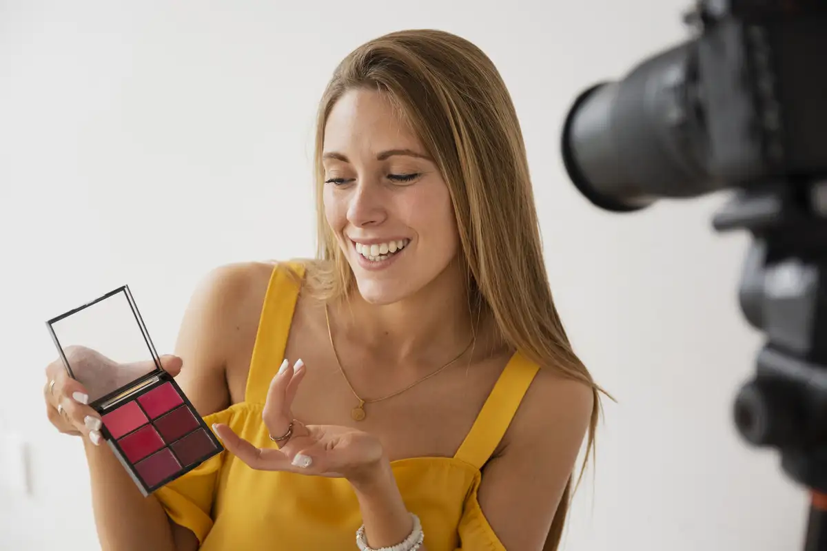 female blogger filming makeup tutorial
