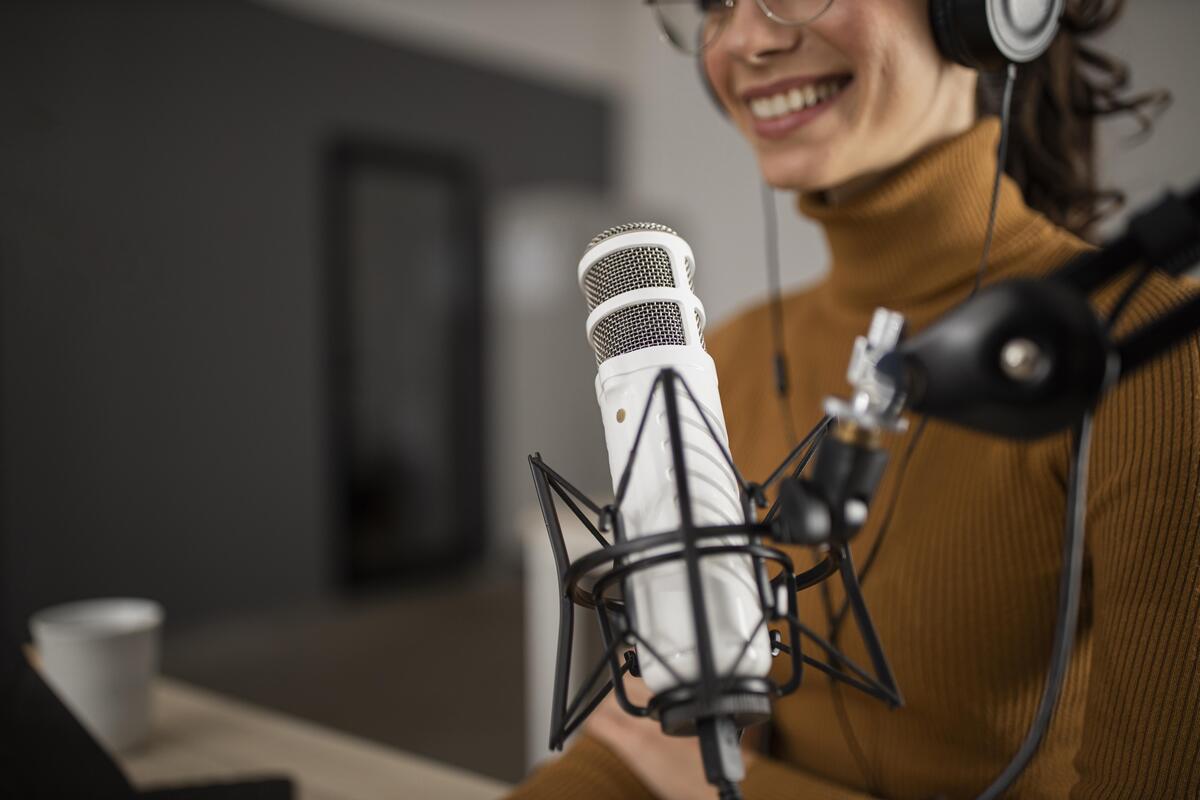 woman broadcasting radio while smiling