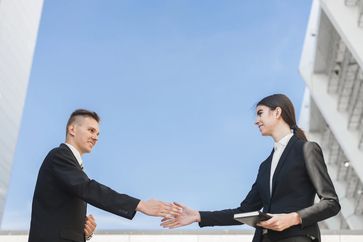 businessman and businesswoman shaking hands